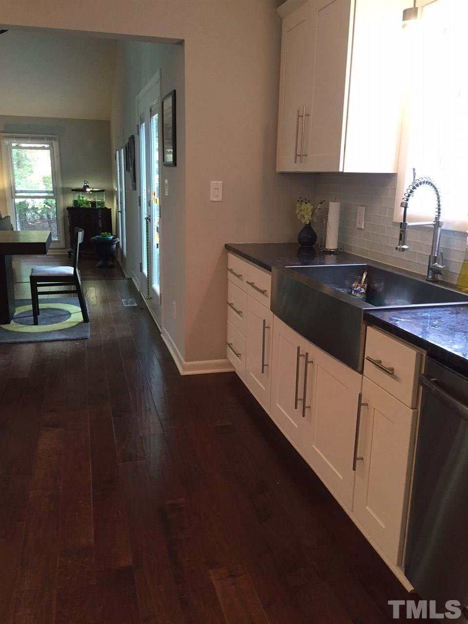 5400 Sylvan Lane Raleigh, NC 27613 - Photo 14 of 24 a kitchen with granite countertop a sink a stove and cabinets