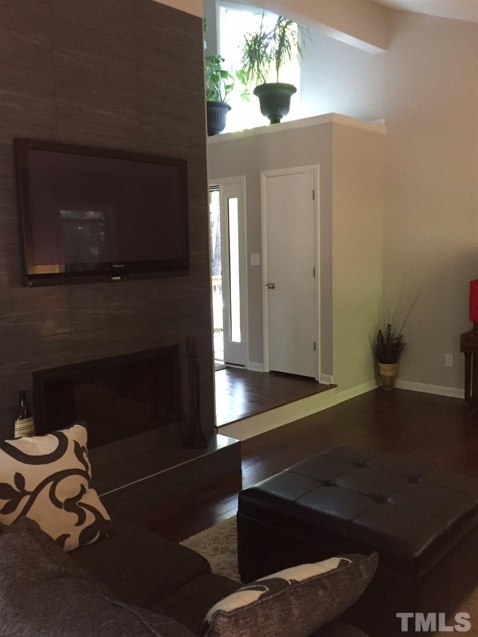 5400 Sylvan Lane Raleigh, NC 27613 - Photo 22 of 24 a living room with furniture and a fireplace