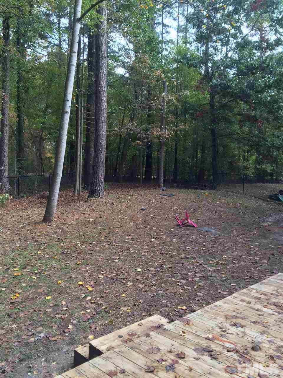 5400 Sylvan Lane Raleigh, NC 27613 - Photo 6 of 24 a backyard of a house with lots of trees