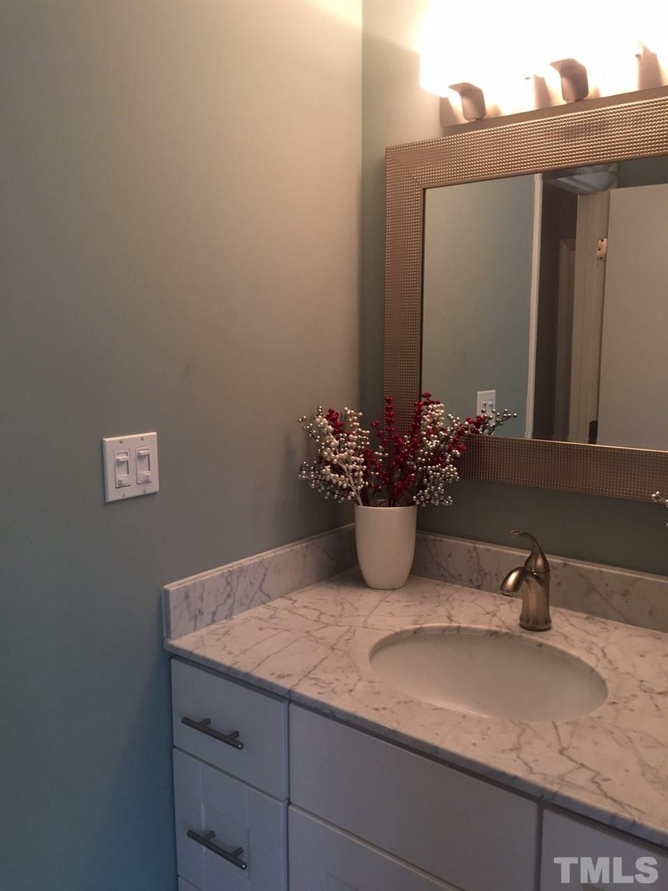 5400 Sylvan Lane Raleigh, NC 27613 - Photo 9 of 24 a bathroom with a granite countertop sink and a mirror
