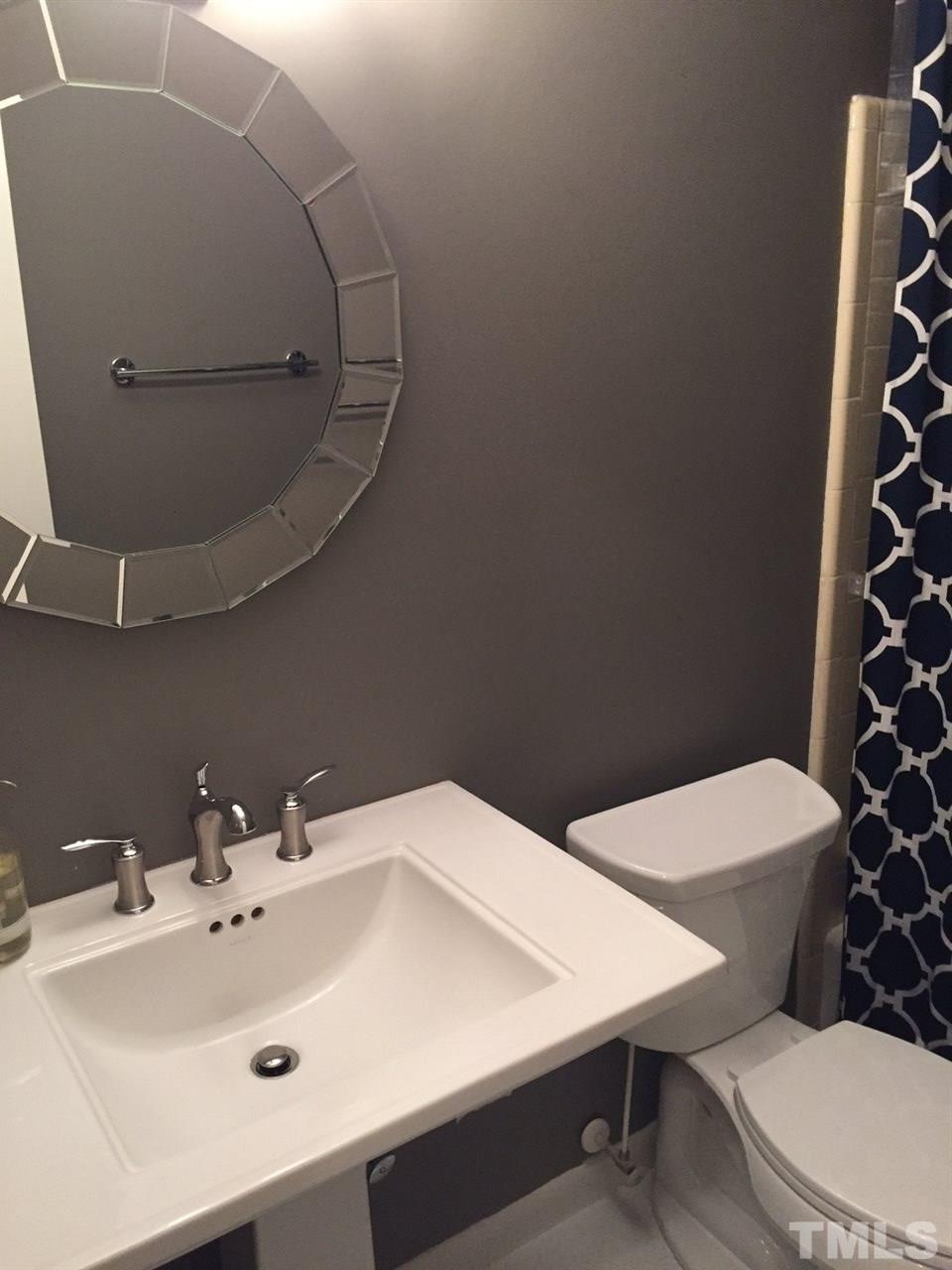 5400 Sylvan Lane Raleigh, NC 27613 - Photo 10 of 24 a bathroom with a sink a toilet and shower