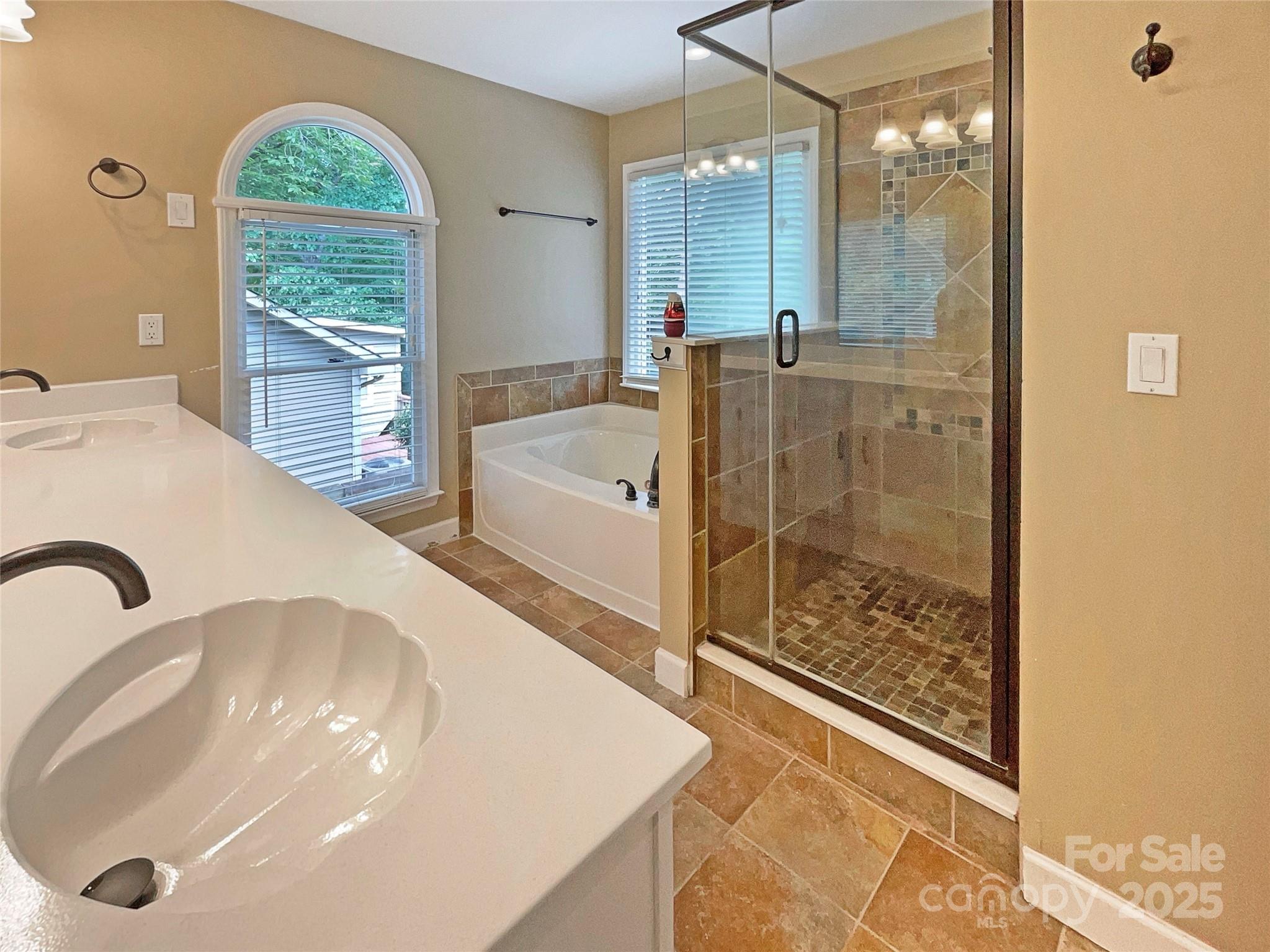 12092 Spinnaker Drive Fort Mill, SC 29708 - Photo 7 of 20 a en suite bathroom with a tub shower and window