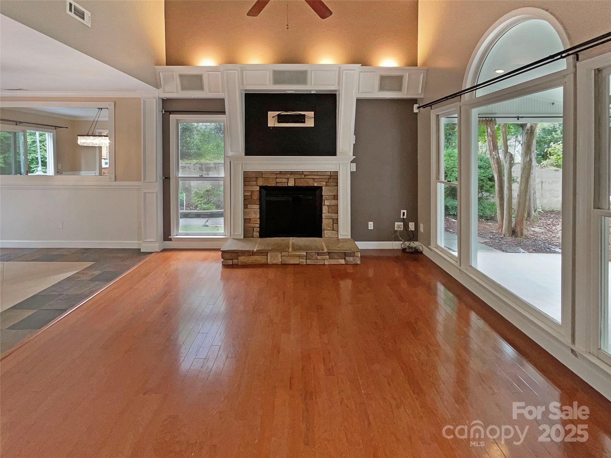 12092 Spinnaker Drive Fort Mill, SC 29708 - Photo 9 of 20 a view of a livingroom with wooden floor a fireplace and window