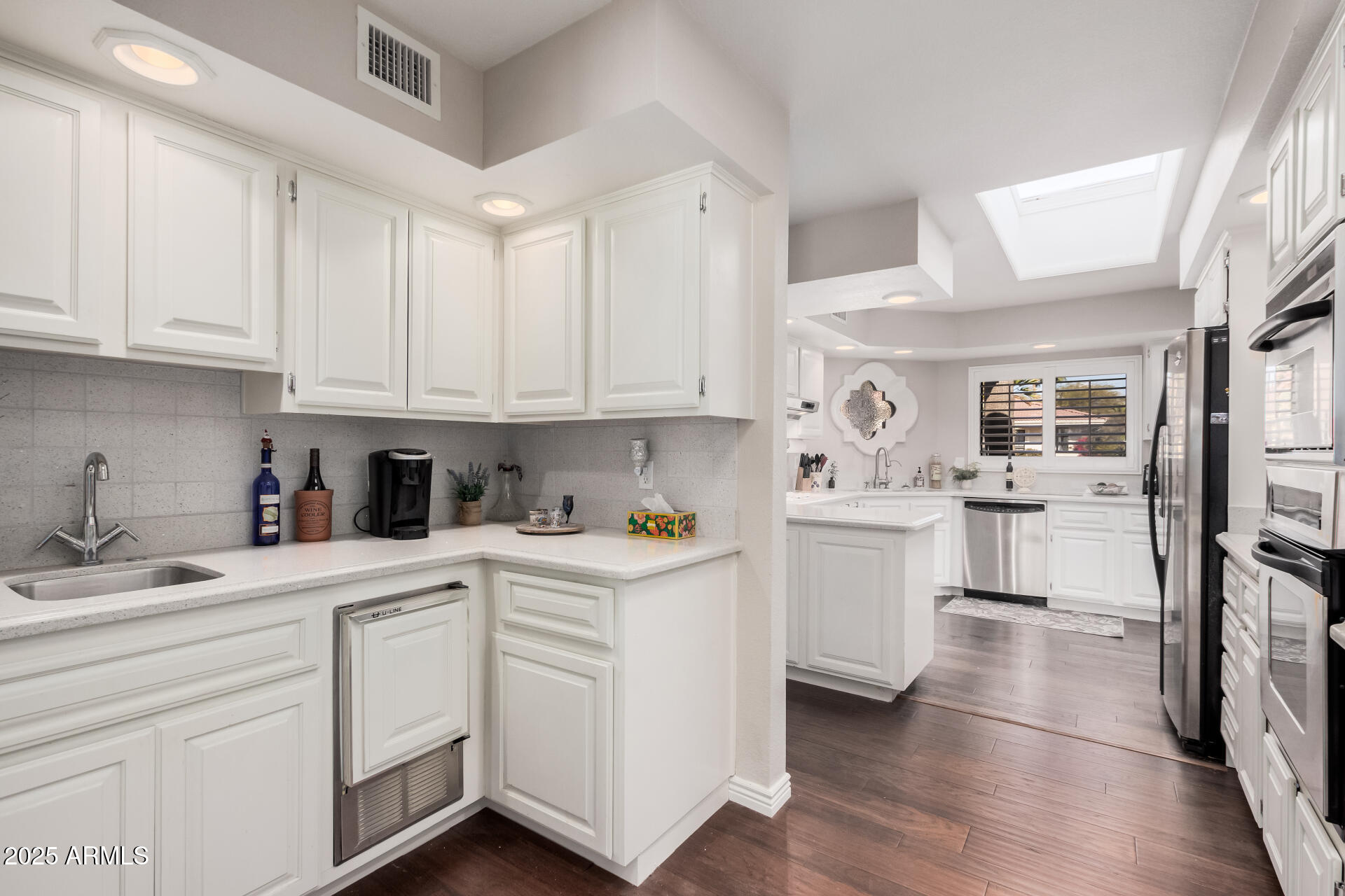 19127 East Wiki Way Rio Verde, AZ 85263 - Photo 22 of 70 a kitchen with white cabinets and appliances