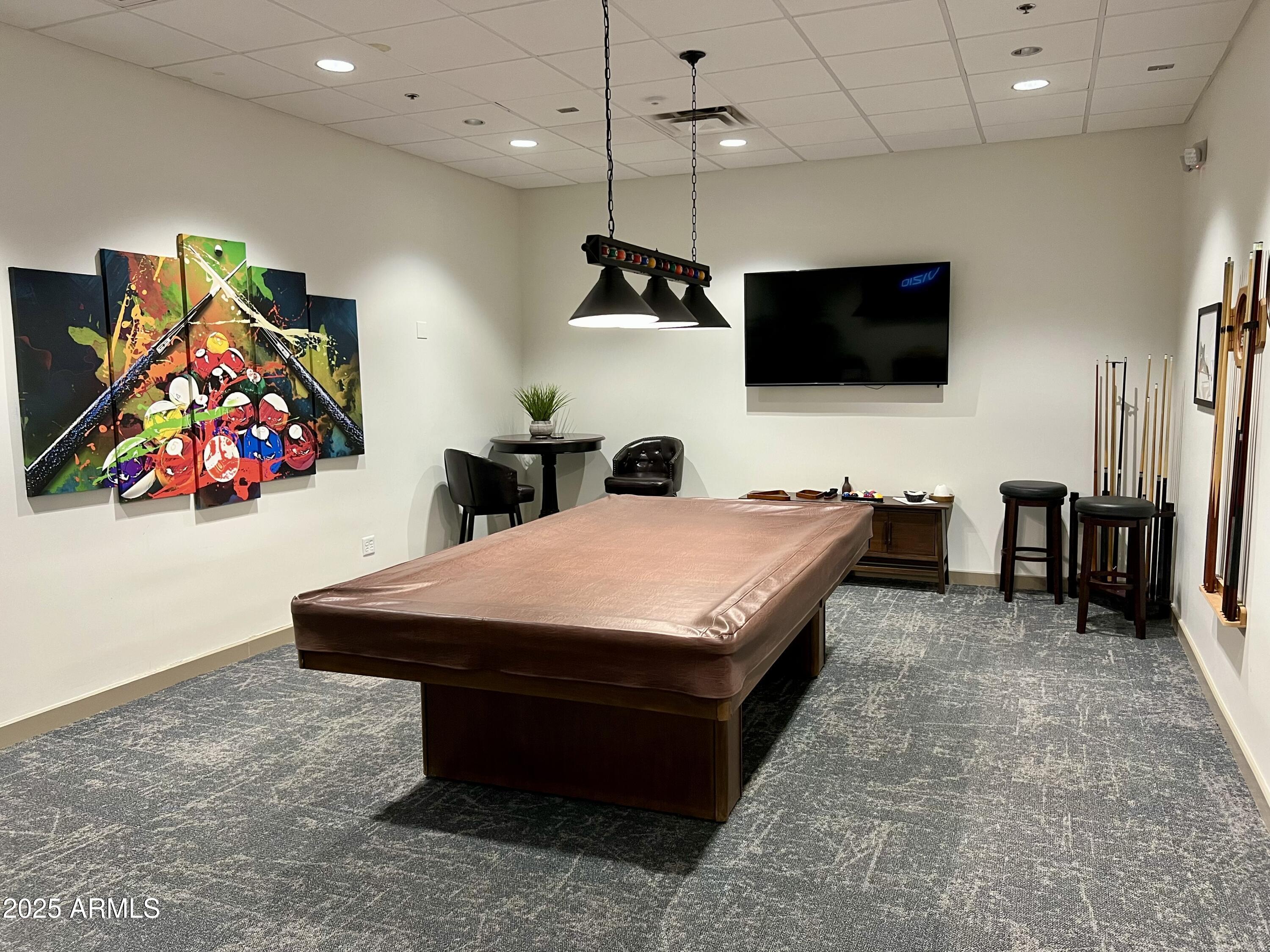 19127 East Wiki Way Rio Verde, AZ 85263 - Photo 64 of 70 a room with furniture a flat screen tv and a ceiling fan