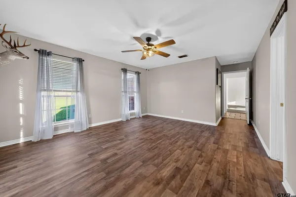 a view of a livingroom with a hardwood floor and a ceiling fan