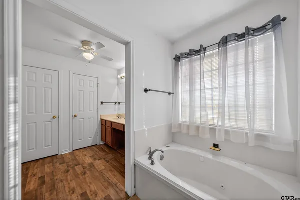 a spacious bathroom with a tub shower and sink