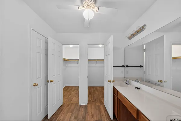 a spacious bathroom with a double vanity sink a mirror and shower