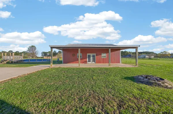 a view of a house with a yard and sitting area
