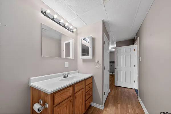 a bathroom with a sink a mirror and a shower