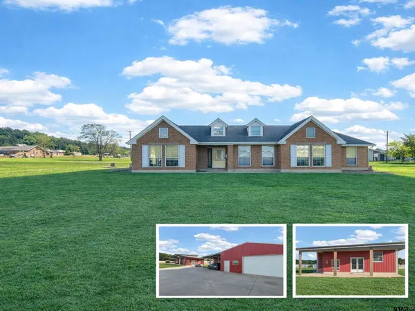 a view of a house next to a yard with big trees