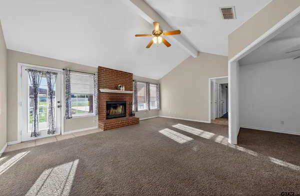 a view of a livingroom with an empty space and a fireplace