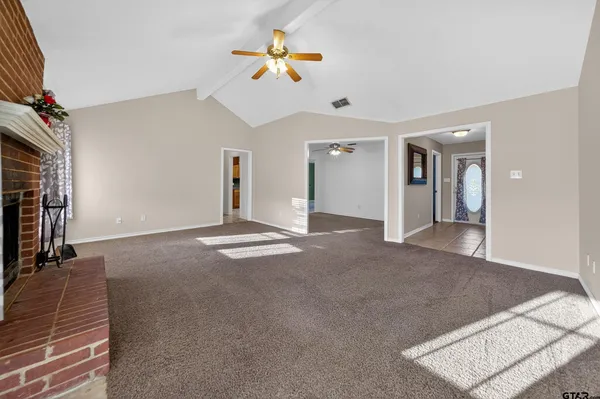 a view of a livingroom with a ceiling fan and window