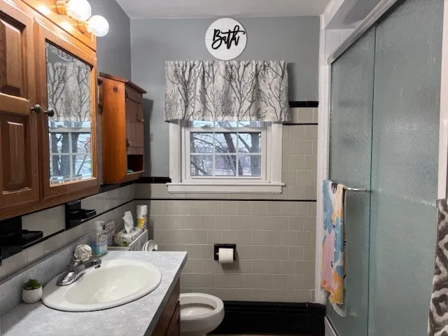 a bathroom with a sink a toilet and a mirror