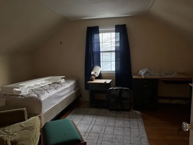 a bed sitting in a bedroom next to a window