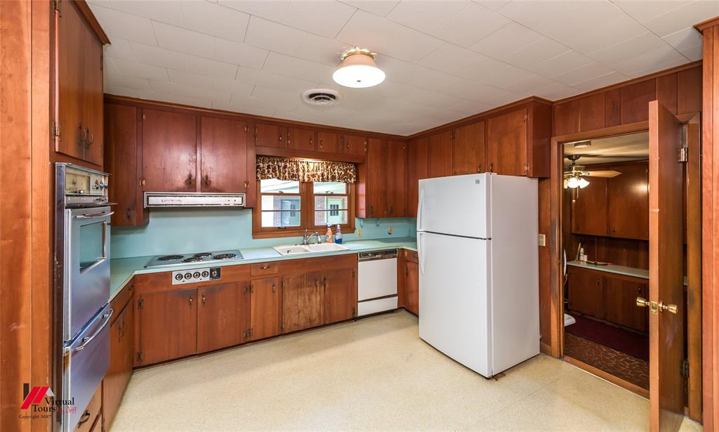205 7th Street Northeast Springhill, LA 71075 - Photo 9 of 40 Wood-finish cabinetry with a built-in double oven