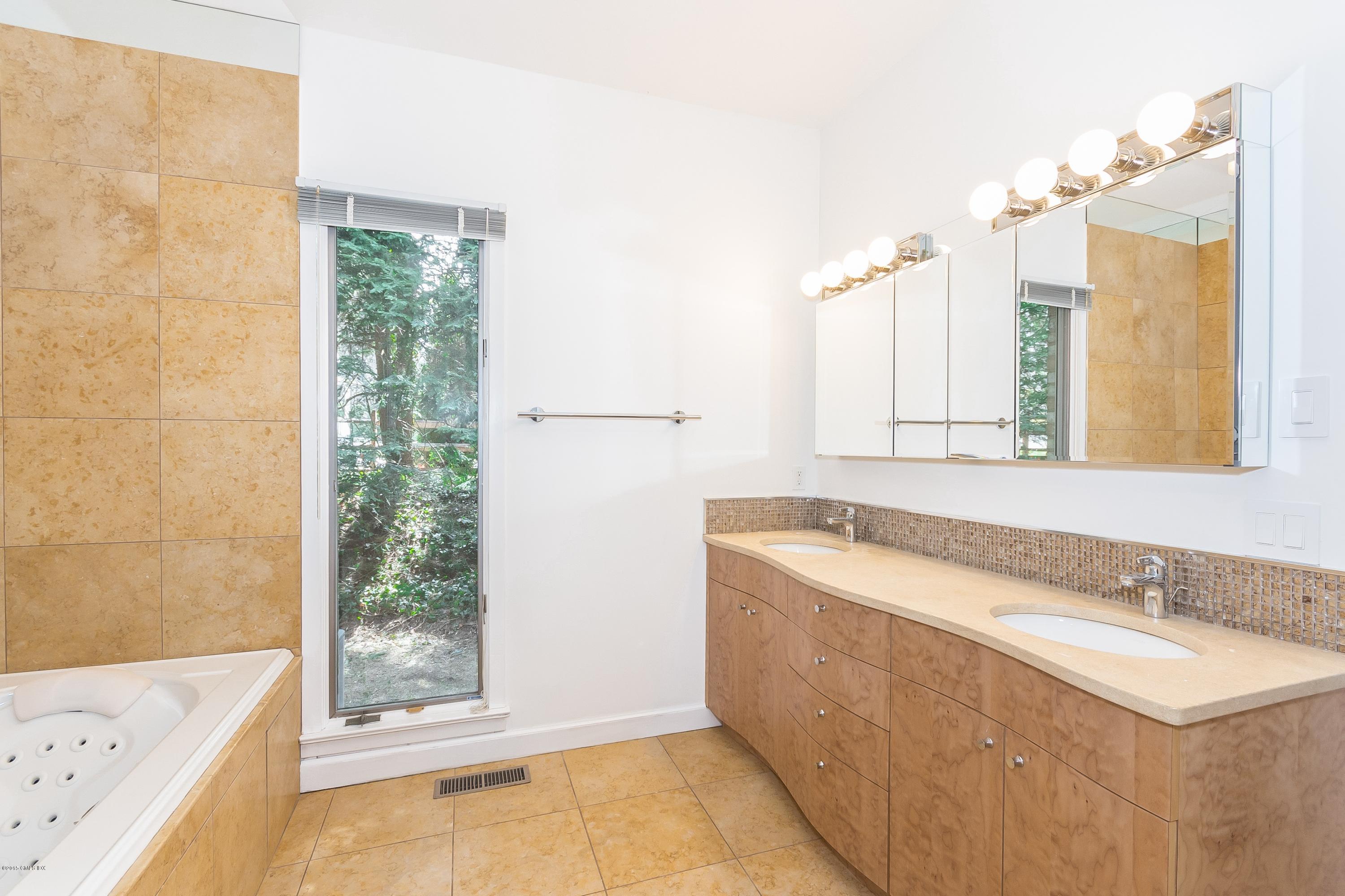 36 Brookridge Drive Greenwich, CT 06830 - Photo 15 of 24 a bathroom with a tub sink and mirror