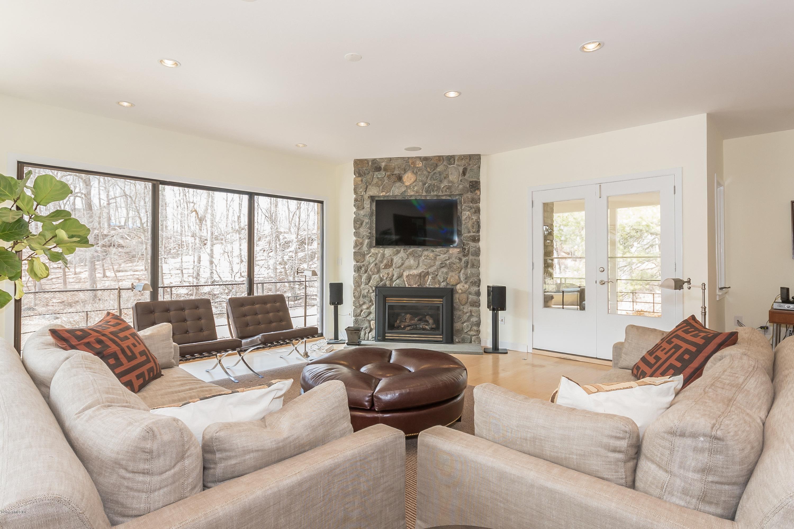36 Brookridge Drive Greenwich, CT 06830 - Photo 4 of 24 a living room with furniture fireplace and a large window