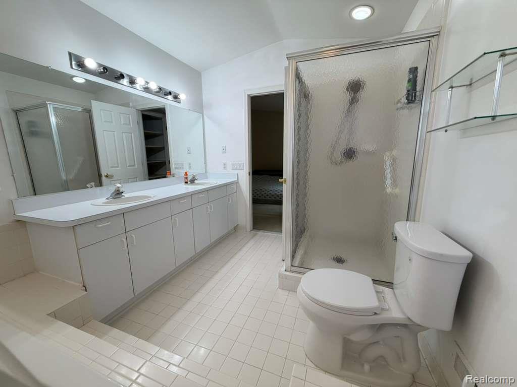 1154 Bluebird Drive Rochester, MI 48307 - Photo 25 of 34 Bathroom featuring a dual vanity with integrated sinks and ample under-counter storage