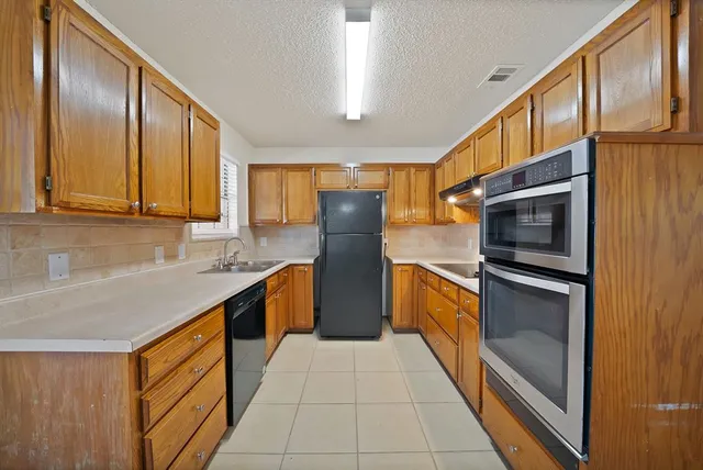 a kitchen with stainless steel appliances granite countertop refrigerator a sink and dishwasher