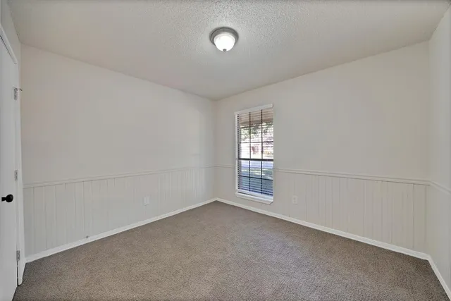 an empty room with a empty space and windows