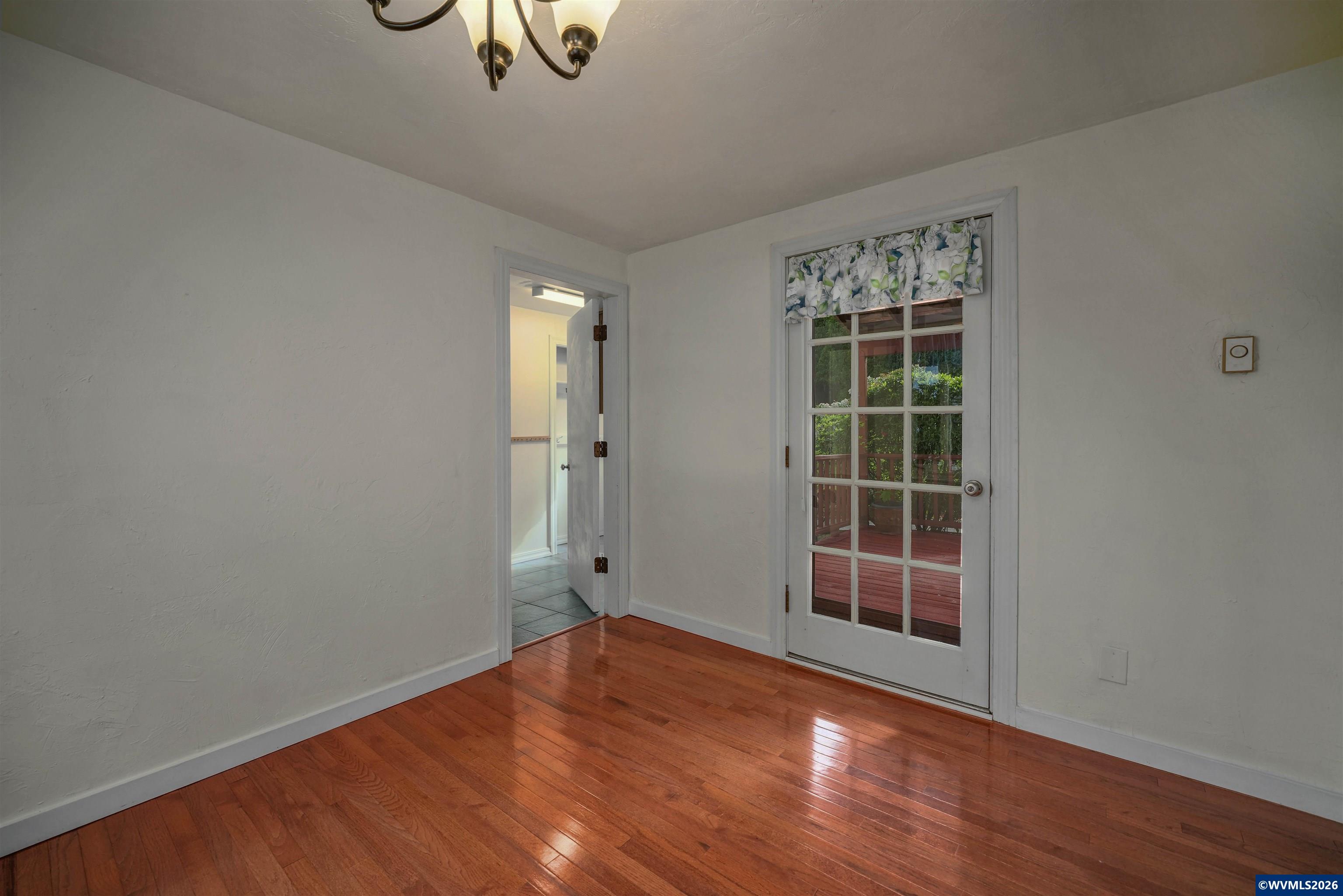 220 Northwest Downy Drive Sublimity, OR 97385 - Photo 18 of 47 an empty room with wooden floor and windows