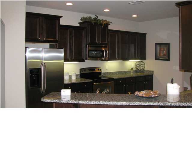 621 Red Fern Road Crestview, FL 32536 - Photo 1 of 2 a kitchen with stainless steel appliances kitchen island granite countertop a refrigerator and a sink