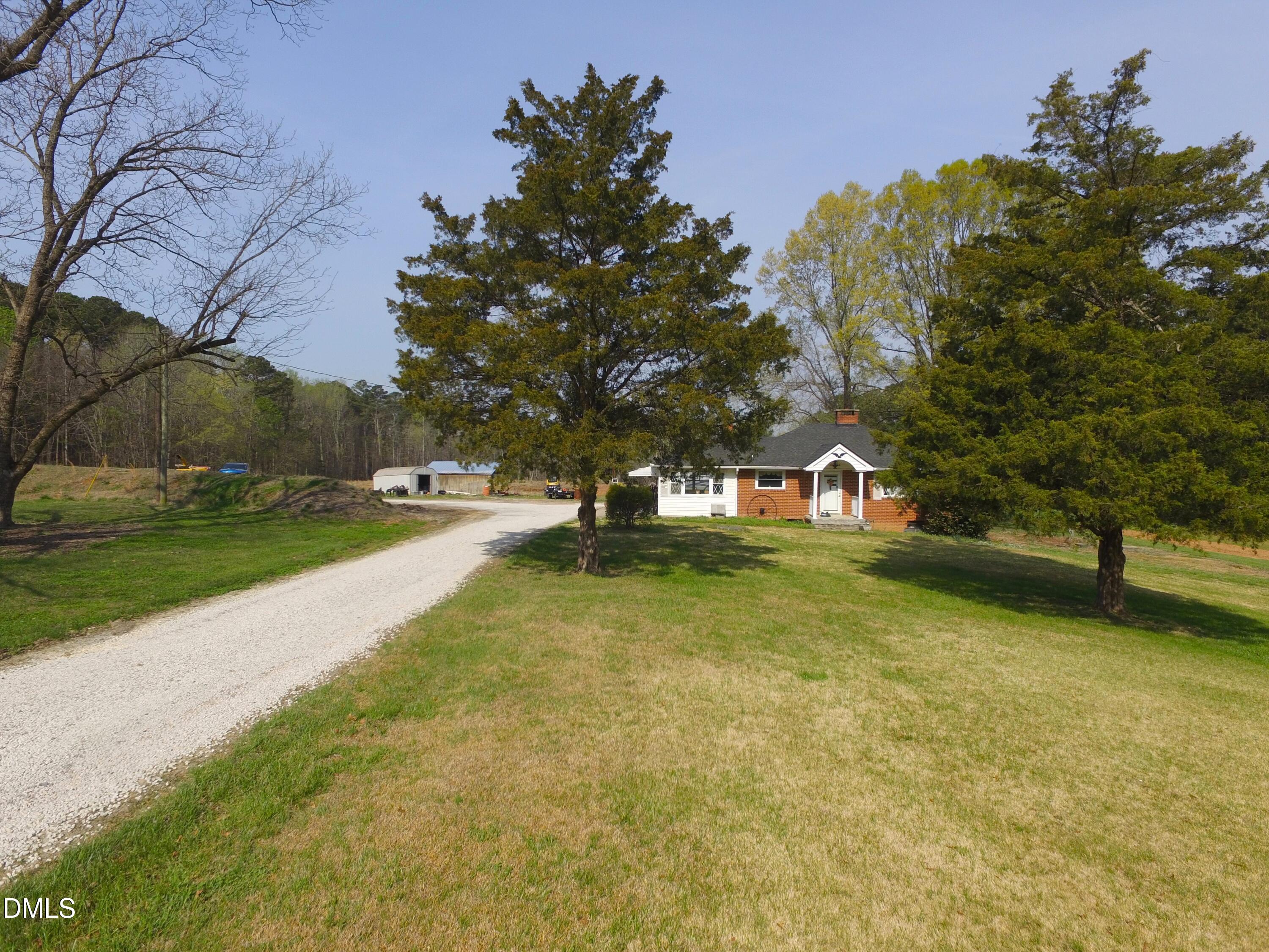 a view of yard with swimming pool and trees