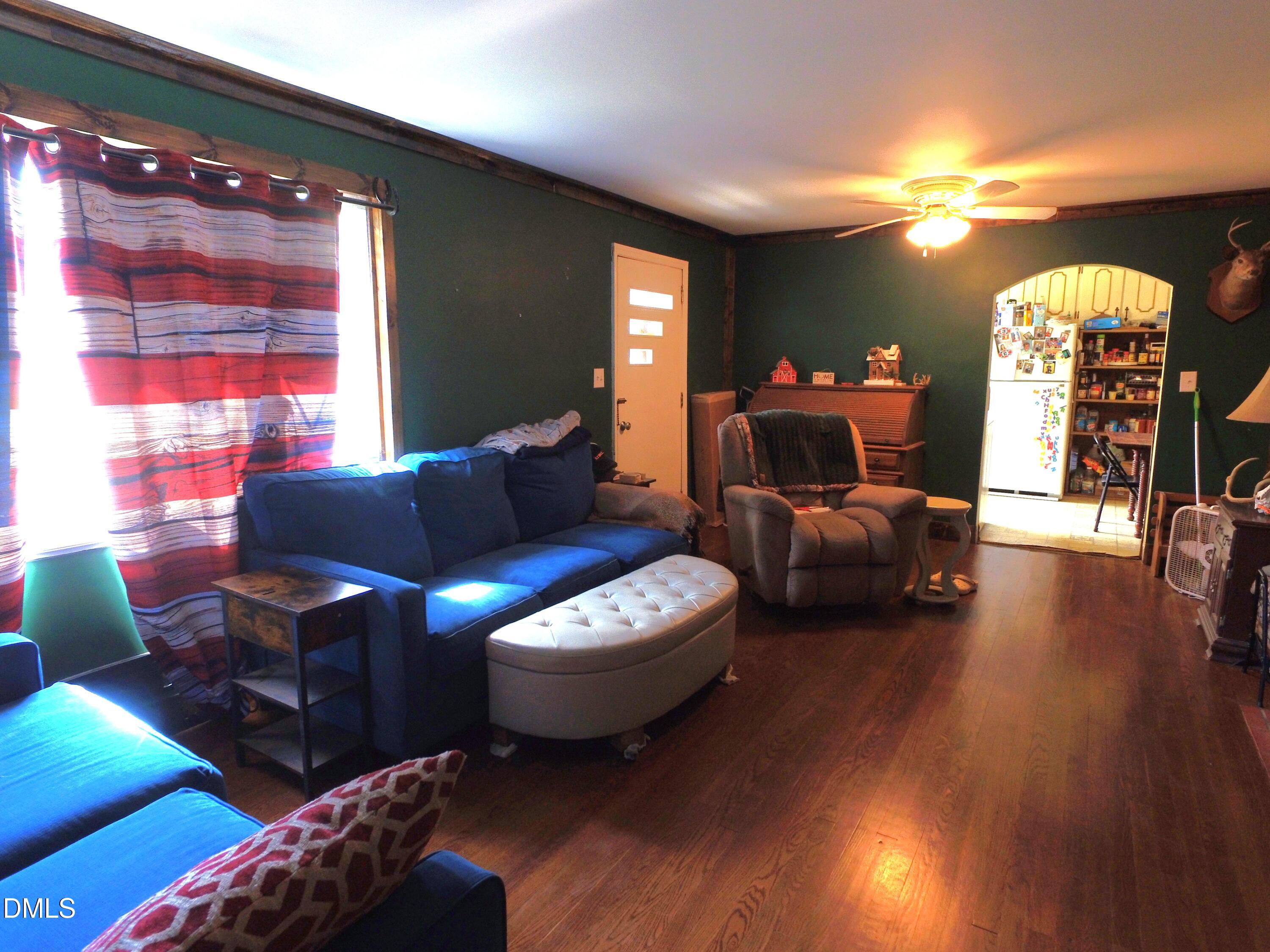 2917 Redwood Road Durham, NC 27704 - Photo 9 of 11 a living room with furniture a lamp and a window