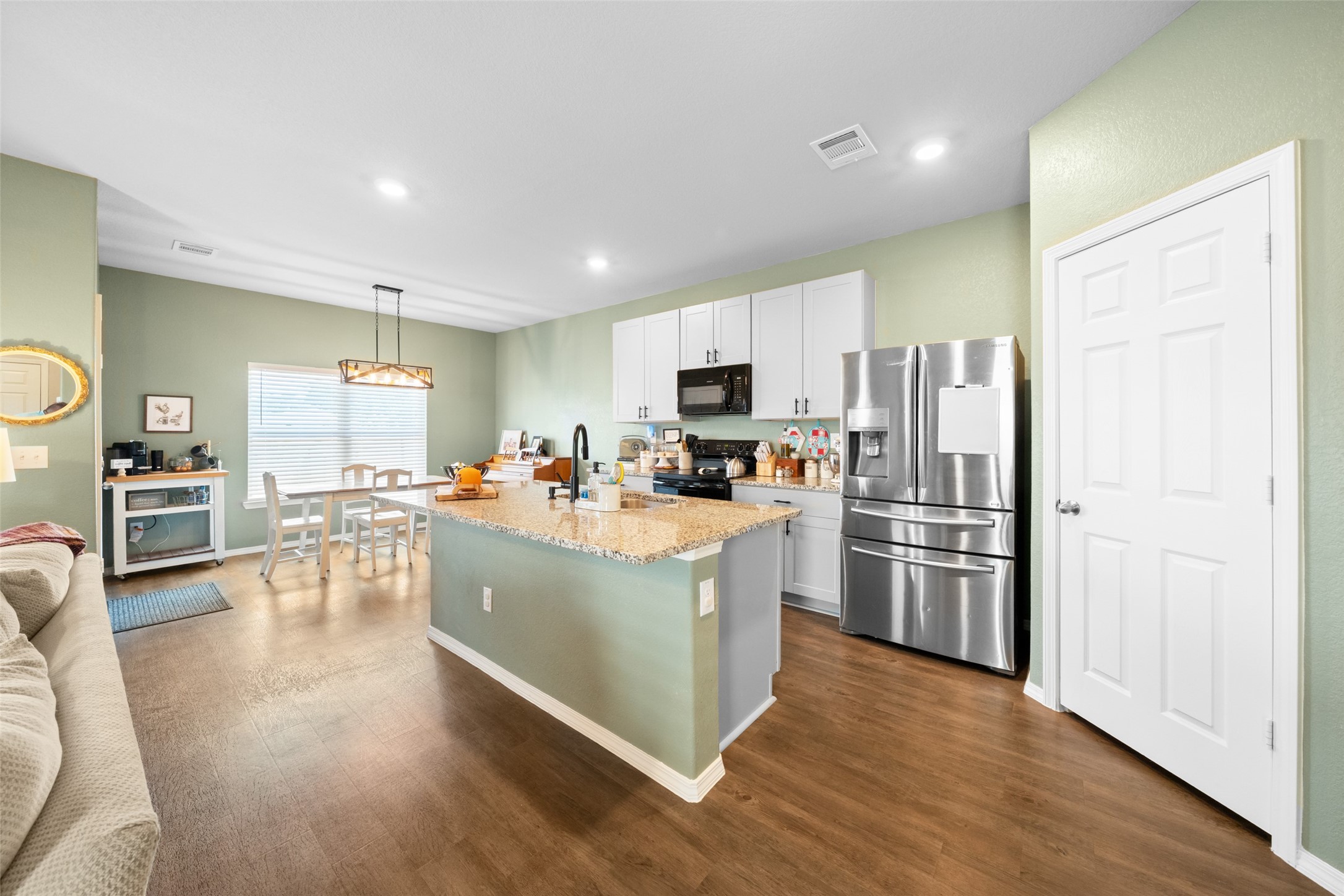 819 Faison Court Montgomery, TX 77316 - Photo 11 of 28 a kitchen with stainless steel appliances a refrigerator and a stove top oven