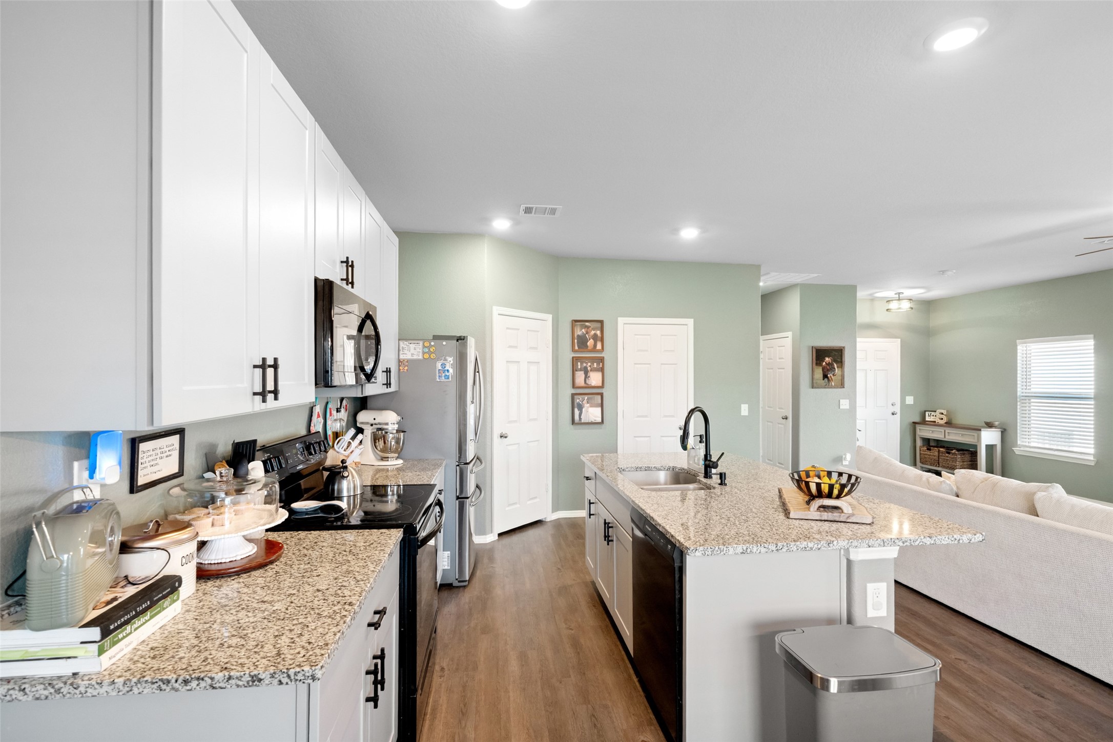 819 Faison Court Montgomery, TX 77316 - Photo 13 of 28 a kitchen with granite countertop a sink stove and cabinets