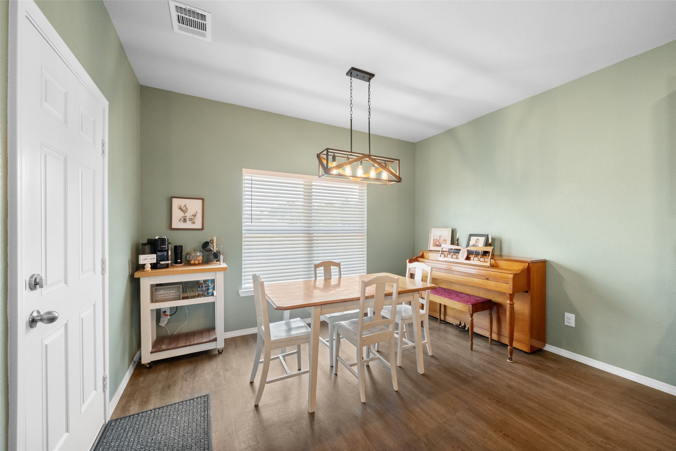 819 Faison Court Montgomery, TX 77316 - Photo 14 of 28 a view of a dining room with furniture wooden floor and a chandelier