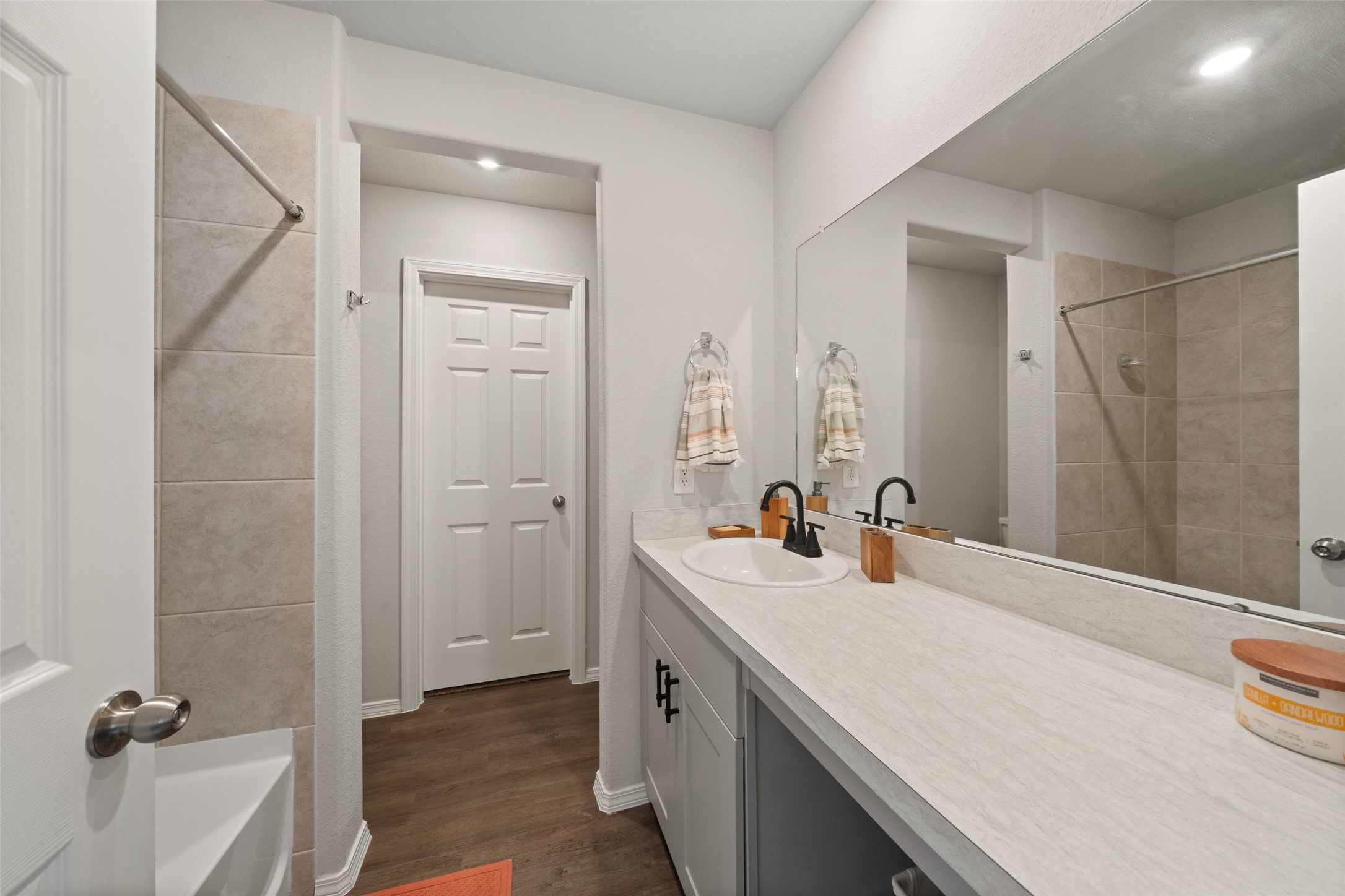 819 Faison Court Montgomery, TX 77316 - Photo 21 of 28 a bathroom with a double vanity sink a mirror and a bathtub