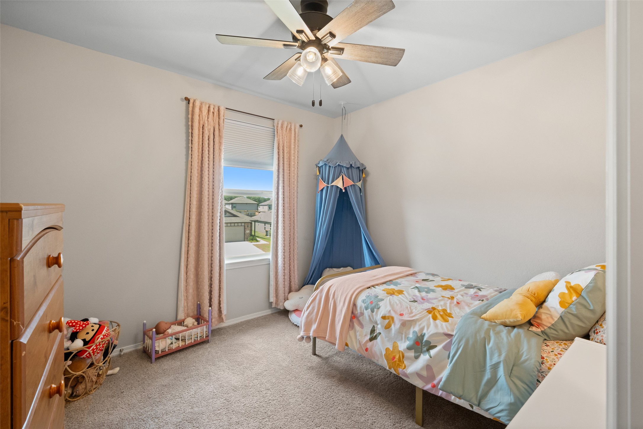 819 Faison Court Montgomery, TX 77316 - Photo 23 of 28 a bedroom with a bed and a chandelier