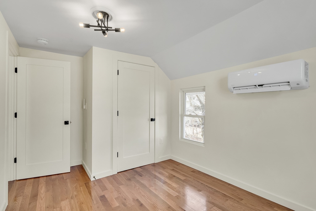 56 Riverview Street Dedham, MA 02026 - Photo 17 of 29 a view of an empty room with a window and wooden floor