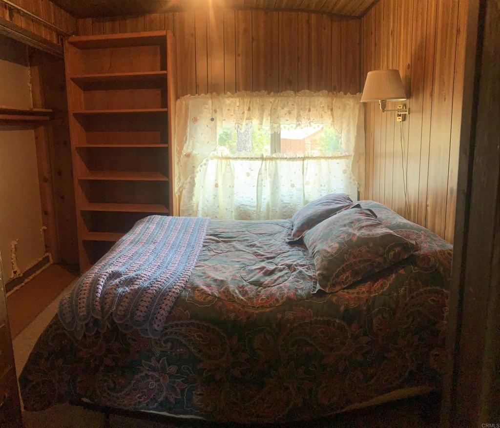 719 Boiling Springs Road Mount Laguna, CA 91948 - Photo 4 of 5 a bed sitting in a bedroom next to a window