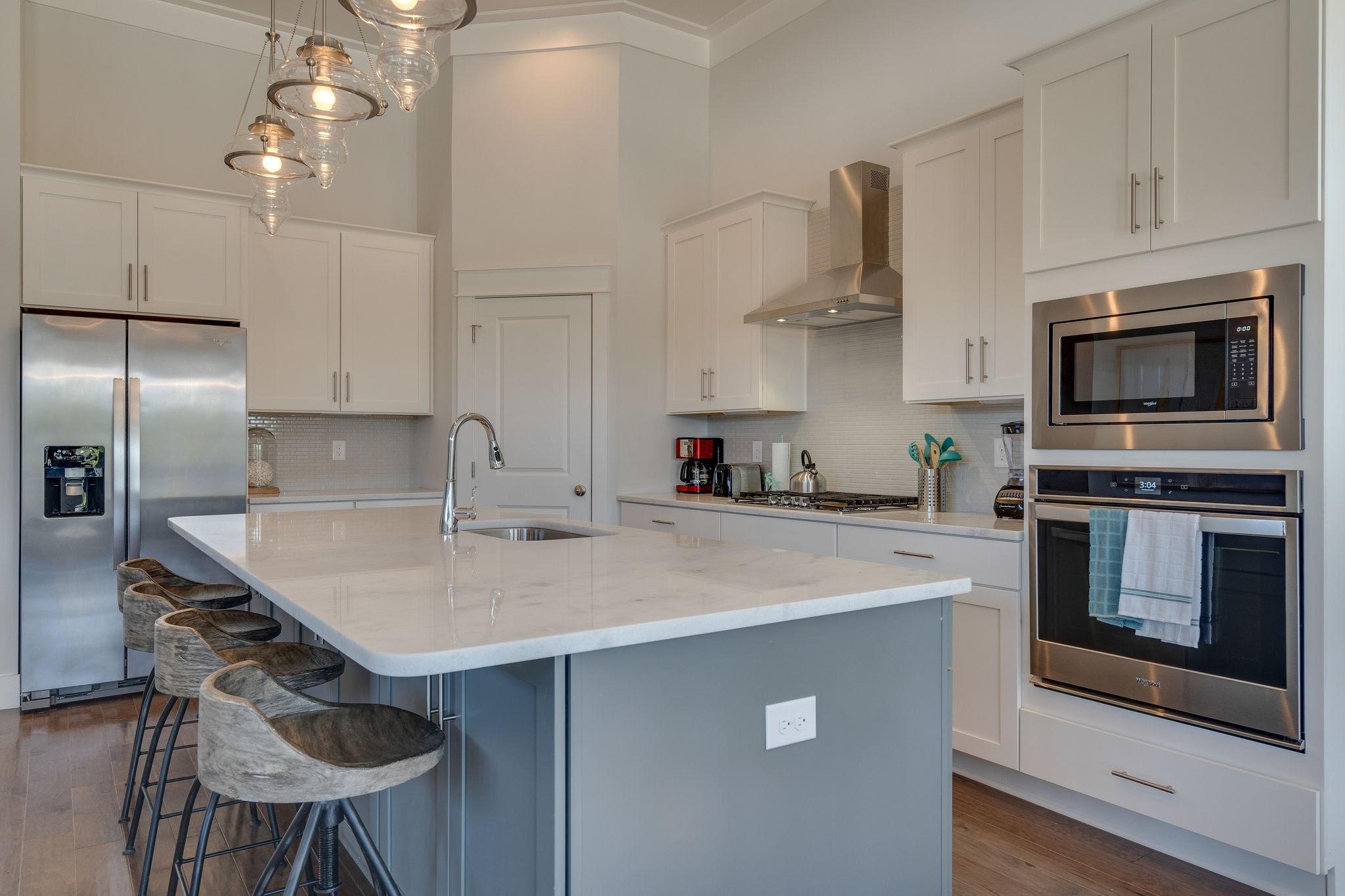 157 Valdare Ln Inlet Beach Inlet Beach, FL 32461 - Photo 21 of 71 a kitchen with stainless steel appliances a kitchen island a stove a table and chairs in it