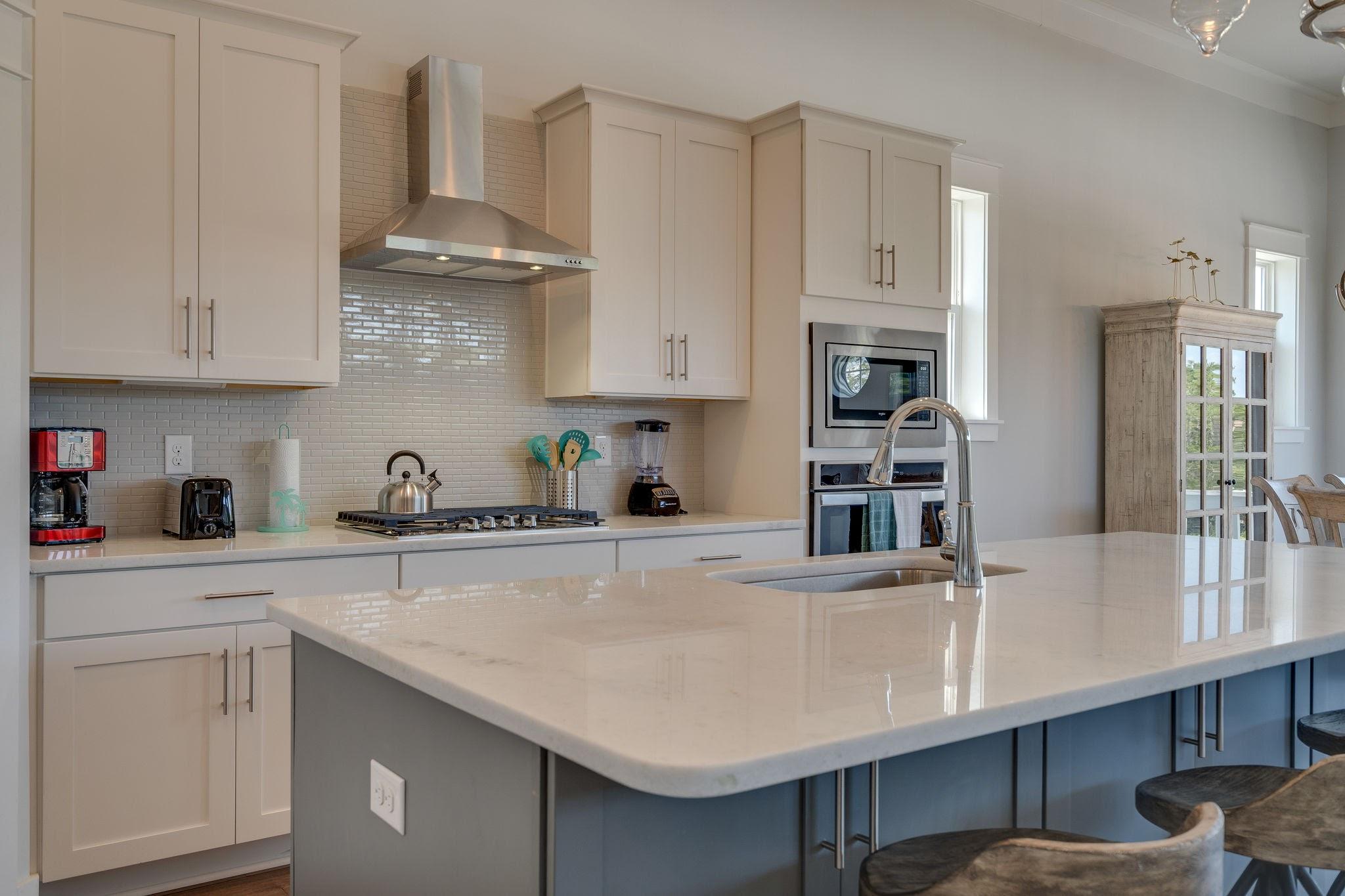 157 Valdare Ln Inlet Beach Inlet Beach, FL 32461 - Photo 24 of 71 a kitchen with stainless steel appliances a sink a stove and white cabinets