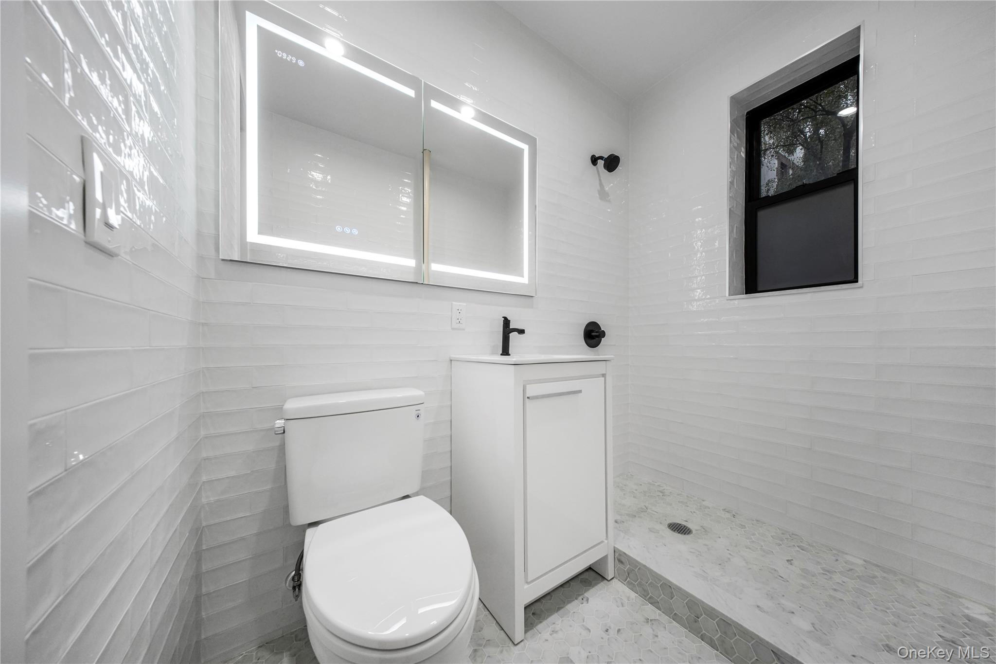 31-14 Crescent Street, Unit 5B Queens, NY 11106 - Photo 5 of 16 Bathroom featuring a stall shower and vanity
