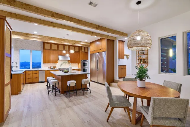 a living room with furniture a table and kitchen chandelier