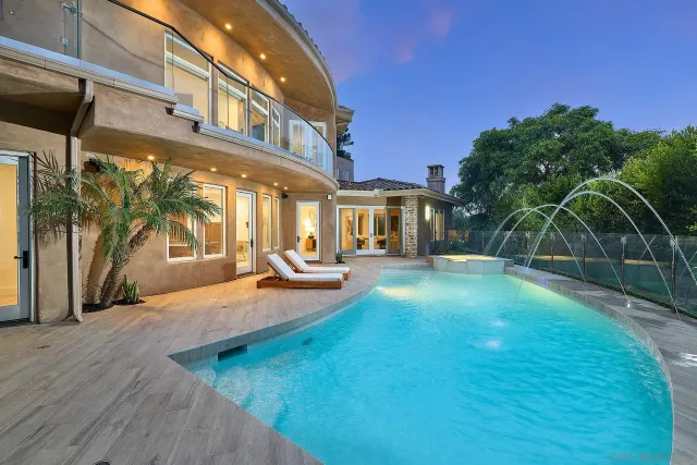 a view of a house with backyard porch and sitting area