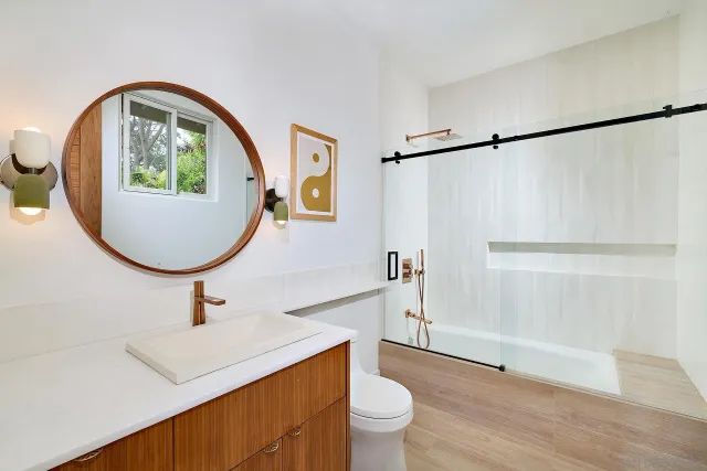 a bathroom with a toilet a sink and a mirror