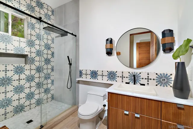 a bathroom with a sink a toilet and shower