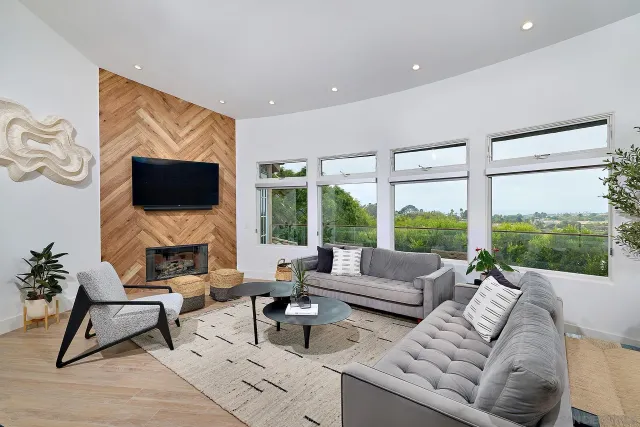 a living room with furniture a flat screen tv and a fireplace