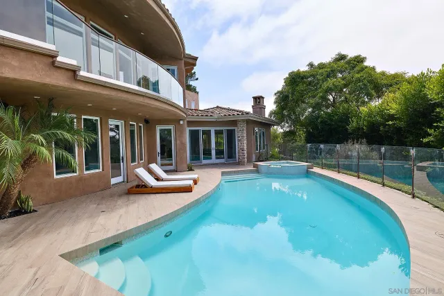 a view of a swimming pool with a lounge chairs
