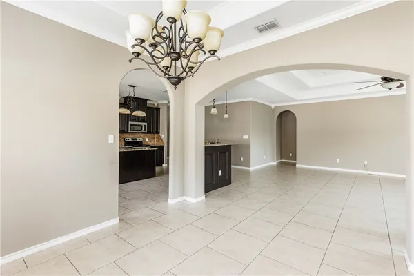 a kitchen with granite countertop cabinets a sink a stove and refrigerator