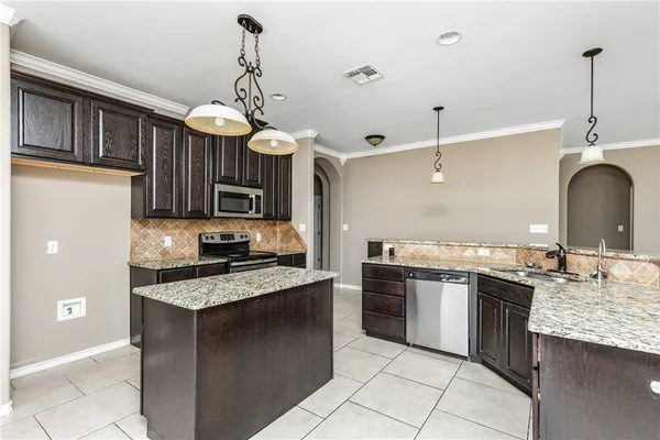 a kitchen with stainless steel appliances granite countertop a stove and a sink