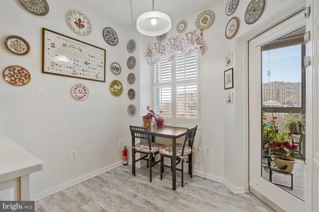a view of a dining room with furniture and a window