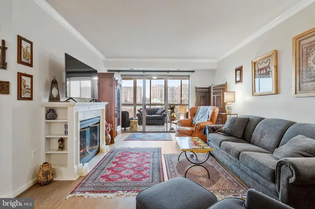 a living room with furniture fireplace and a window