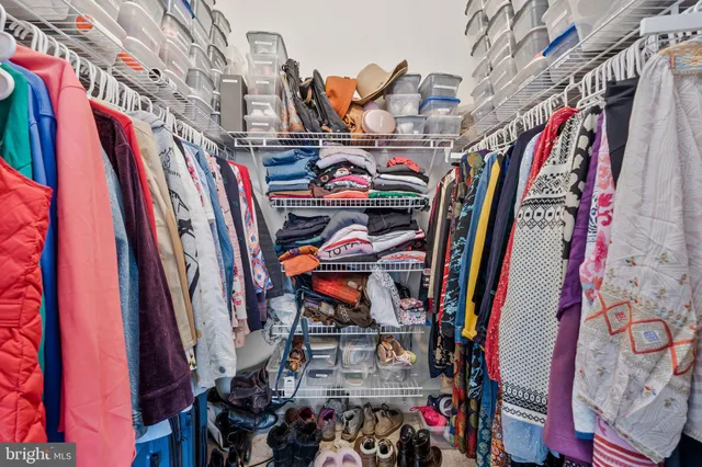 a view of walk in closet with clothes